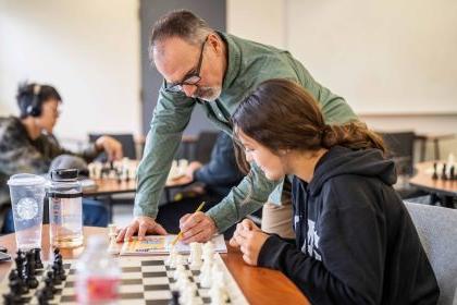 a student and instructor in the chess program